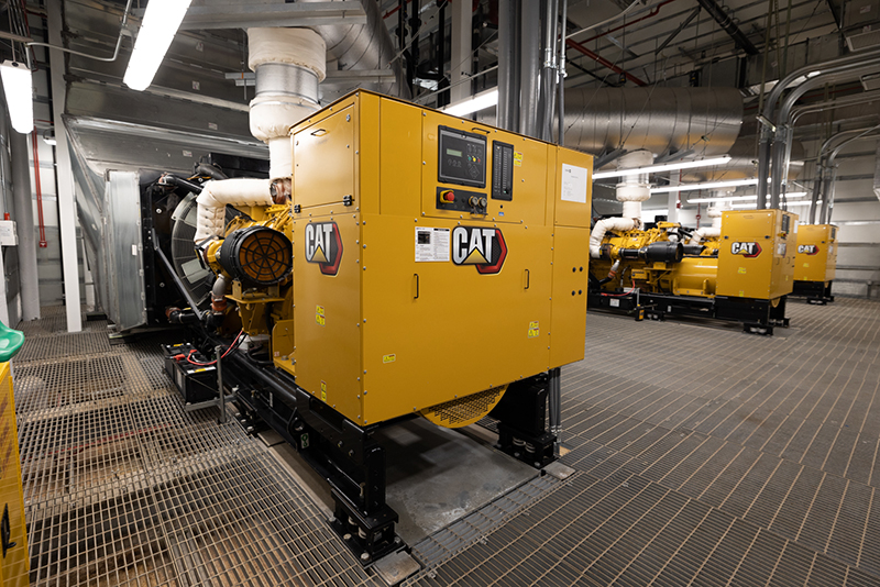 Three yellow and black electric generators