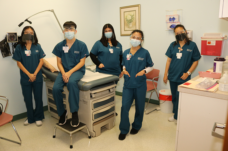 Group of five high school students training as medical assistants