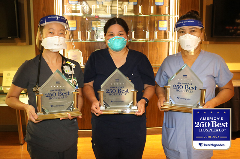 Three Straub medical professionals holding Healthgrade awards
