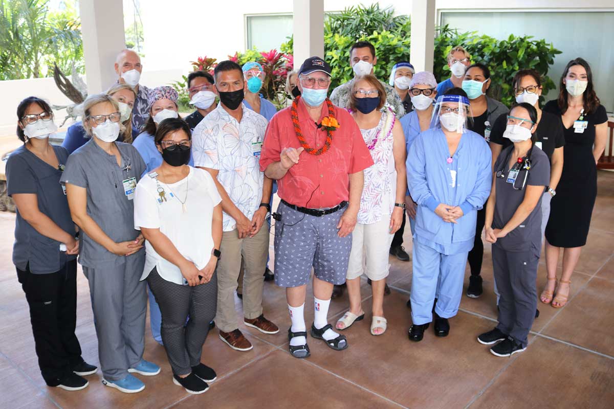 group shot of former covid patient with health care team