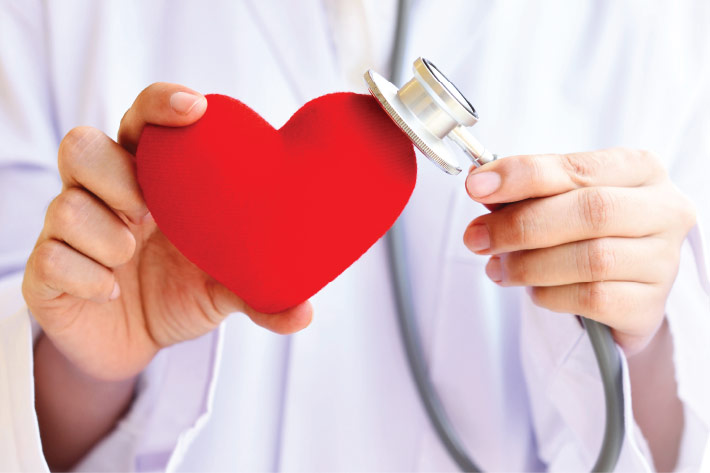 Physician holding a heart shape in honor of Doctors' Day