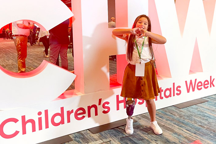 Haumea Friel making a heart with her hands in front of the letters CHW