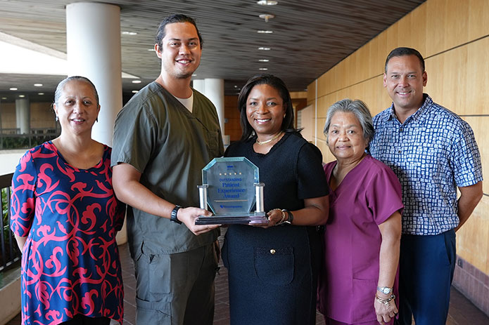 Pali Momi leadership and staff holding Healthgrades Award