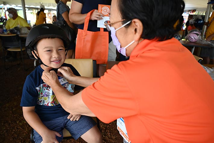 young boy getting fitted for a bicycle helmet