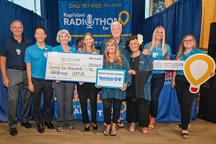 Kapiolani Radiothon participants with giant check donation group shot