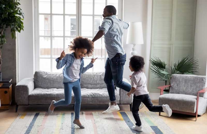 Family being healthy together by exercising in the living room