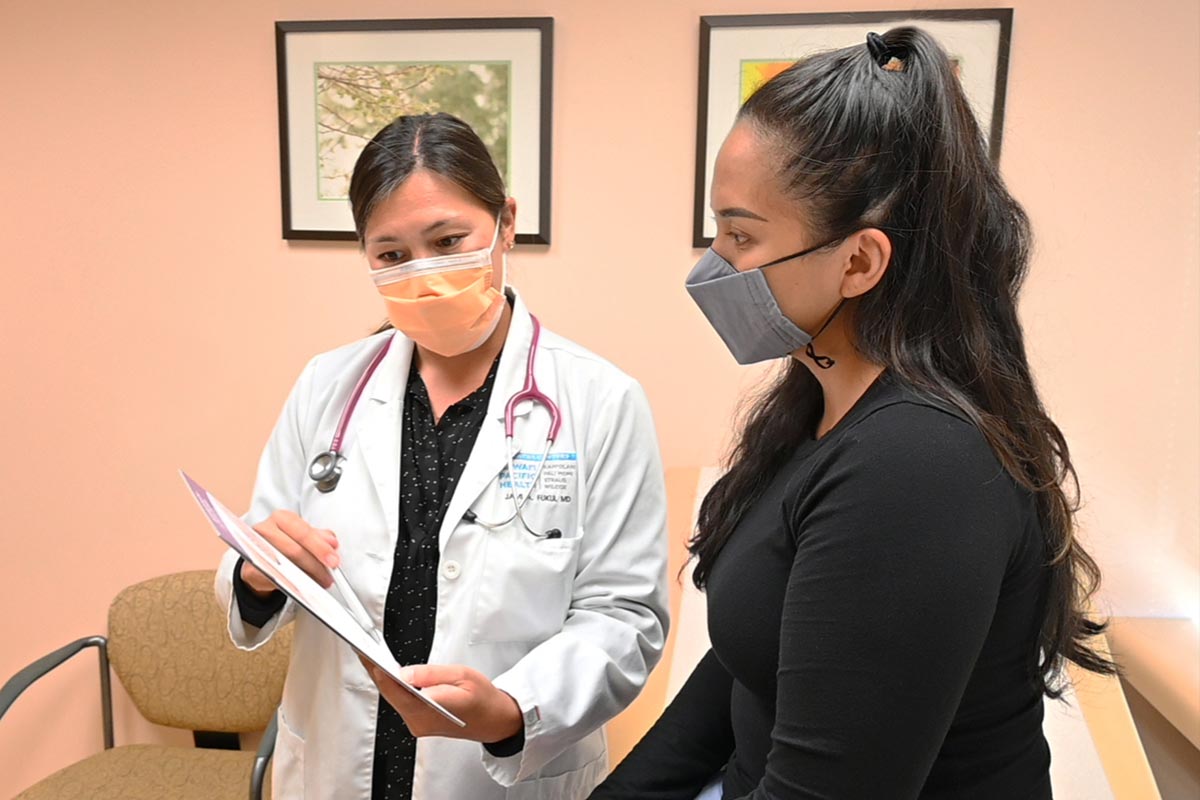 doctor speaks with a patient