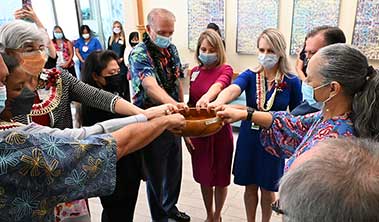 circle of health care leaders at a blessing ceremony at Pali Momi Cancer Center