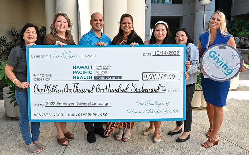 Giant check for a million dollars held by Hawaii Pacific Health employees