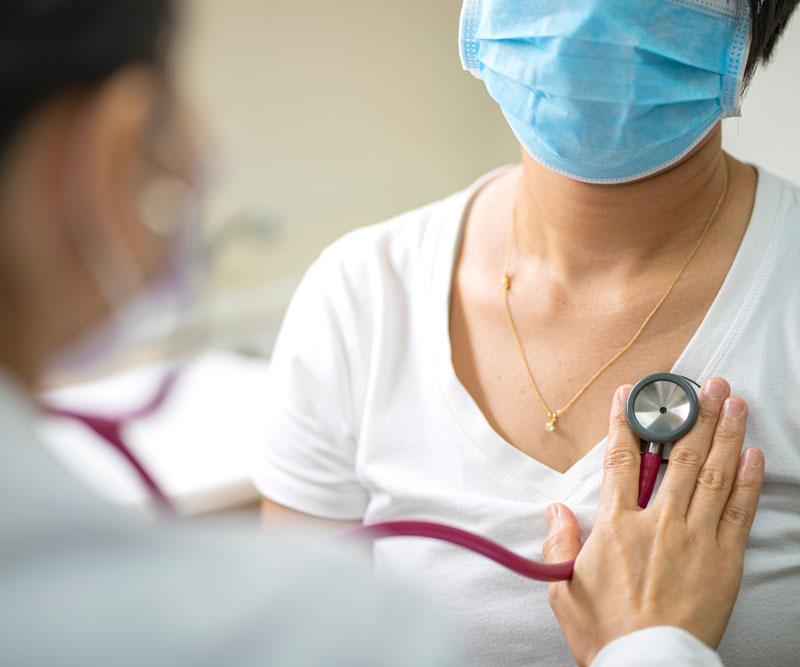woman getting her heart examined by doctor