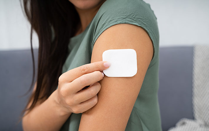 woman putting on a nicotine patch