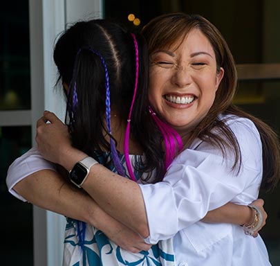 Dr Cherilyn Yee hugs Kalley-Mae.