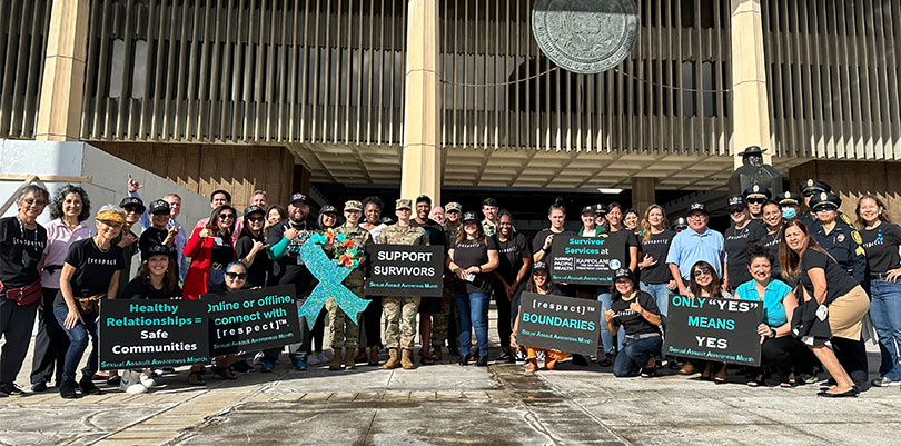 large group shot of people gathered to sign-wave in support of sexual assault awareness