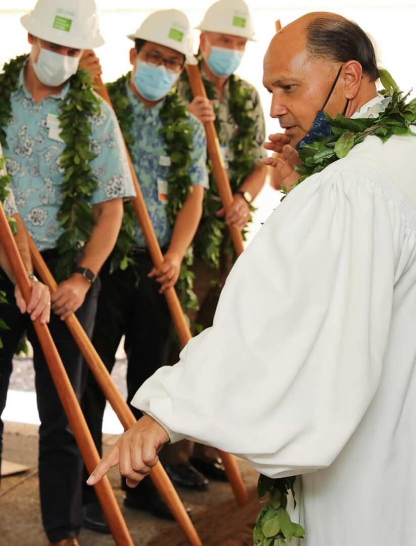 Minister blesses the land as the Straub leadership team breaks ground.