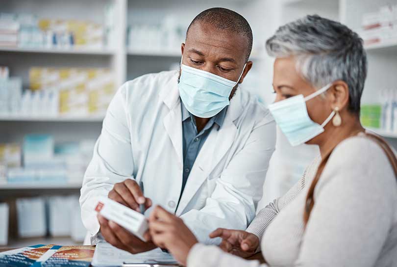 Pharmacist speaking with a woman about her medication.