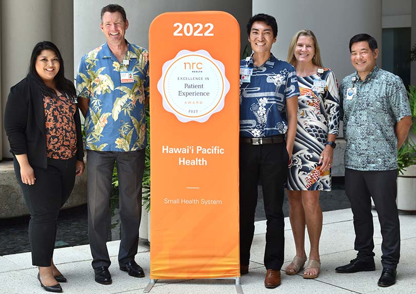 Group shot with banner announcing patient experience award.