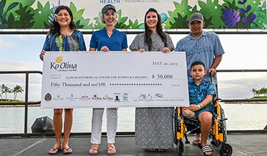 Small group with $50,000 giant check.