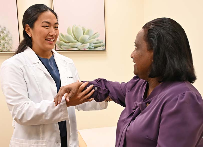 doctor examining female bone and joint patient