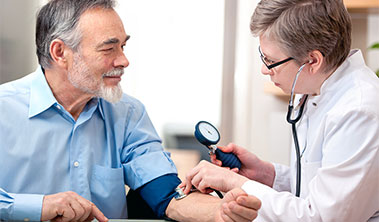 older male patient getting his blood pressure taken