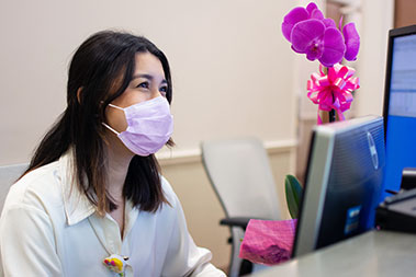 woman working at front desk of medical clinic