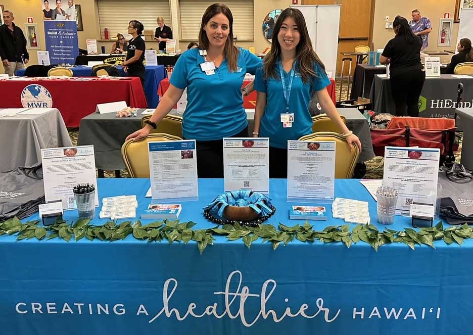 Two recruiters for Hawaii Pacific Health working at a job fair