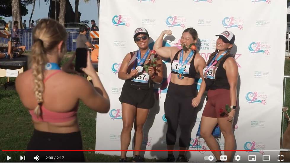 video thumbnail of medal-winning racers posing for pics