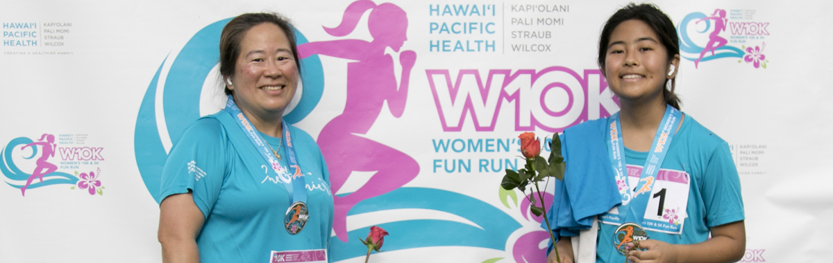 Two smiling women runners at 10K finish line.