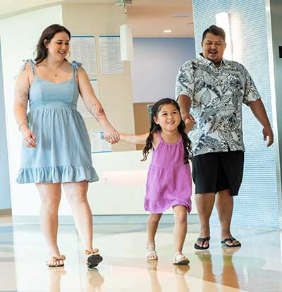 Leila-Rose Coloma happily holding hands with mom and dad