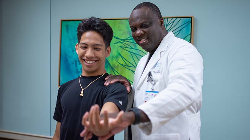 Orthopedic doctor examining a patient's arm.