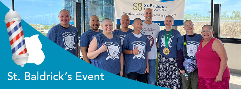 Group of shaved-head people in support of cancer research and kids battling cancer.