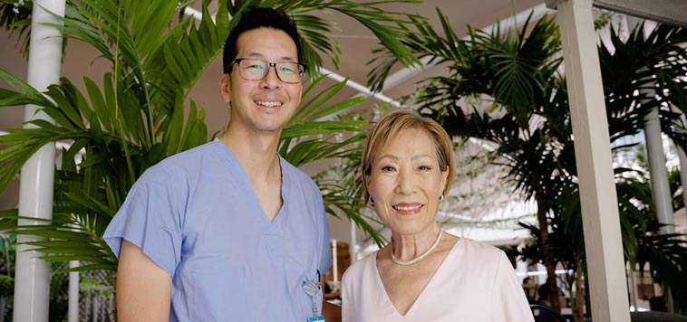 Chung Lucky stands with Dr. Jeremy Lum at Straub Benioff Medical Center