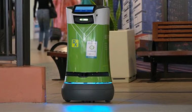 Small green cylindrical robot used for secure pharmacy deliveries.