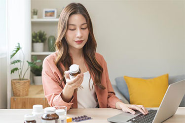 Woman inspecting a supplement packaging.