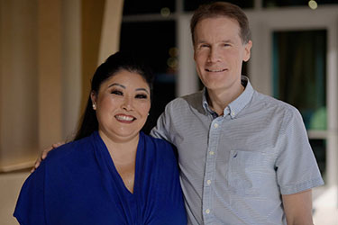 Kelli Ann Okubo and Dr. Andras Bratincsak standing together smiling.
