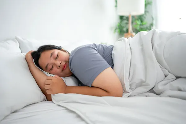 a woman sleeping in bed