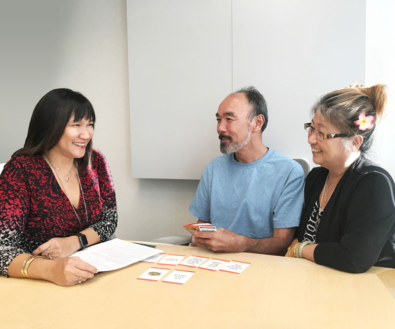 a facilitator speaks with an elderly couple during an advance care planning session