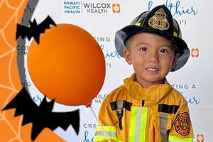 Boy dressed up as a fire fighter for Halloween.
