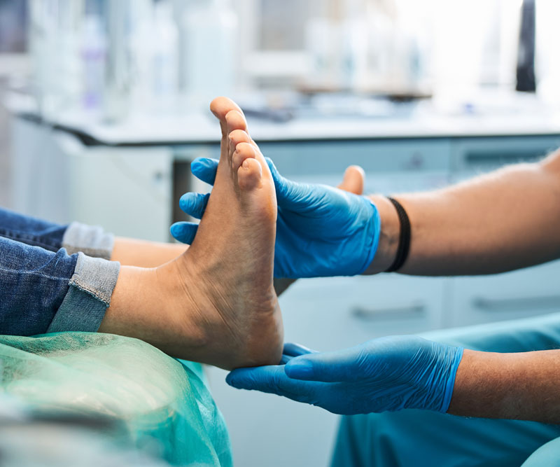 a doctor examines a patient's feet