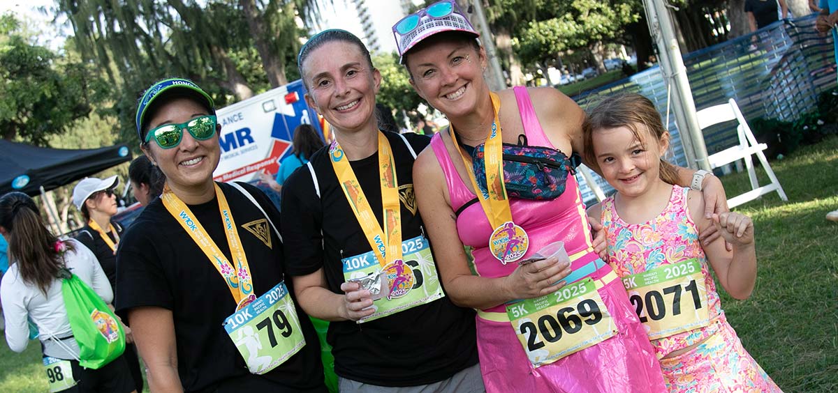 Group of female race finishers with medals.