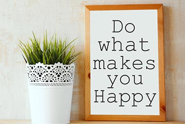 Plant alongside word art reading Do What Makes You Happy.