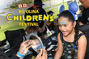 Smiling child getting her face painted and text for Ko Olina Children's Festival.
