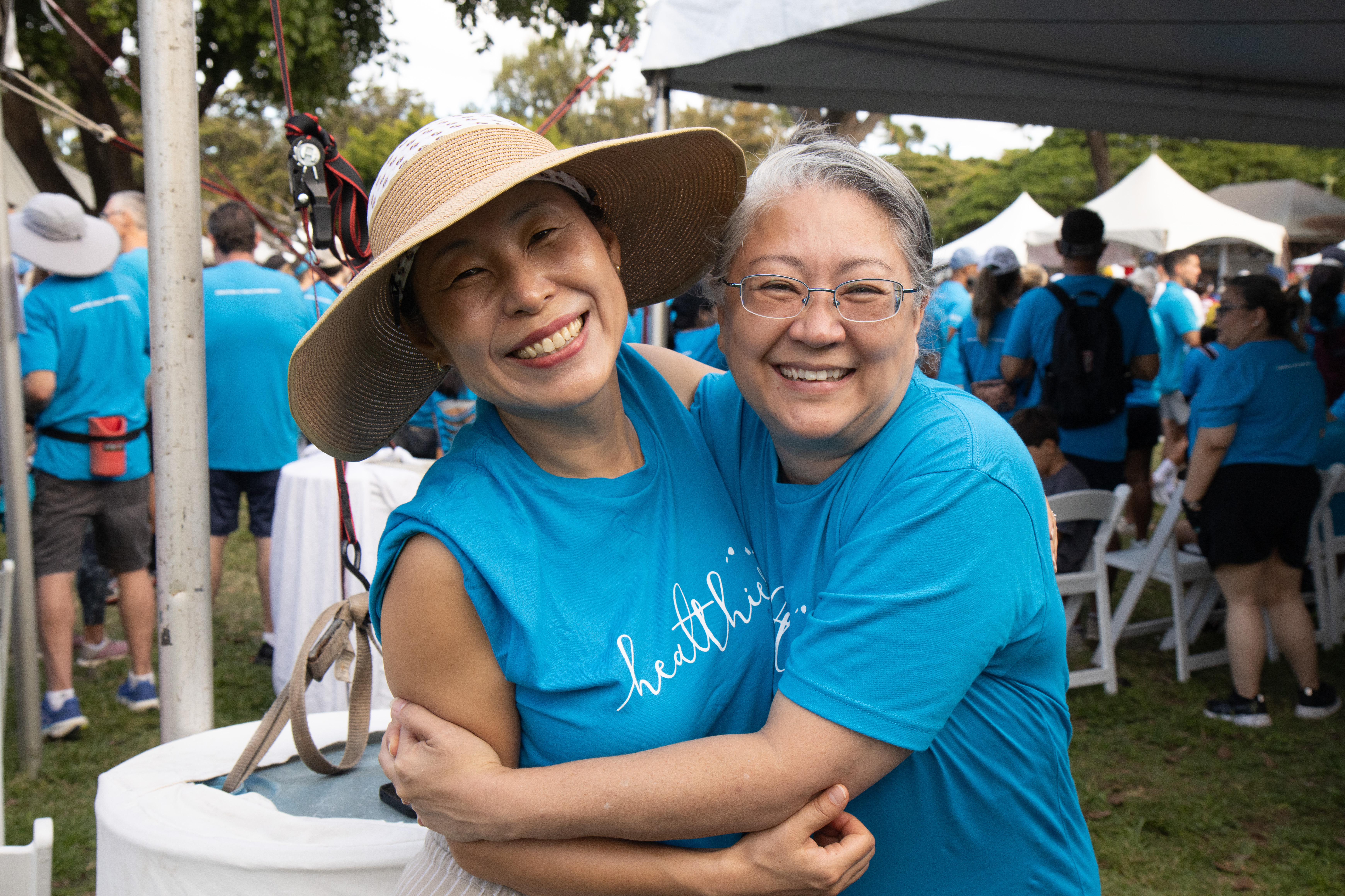 Two women smiling and hugging for the camera at the American Heart Association Heart Walk.