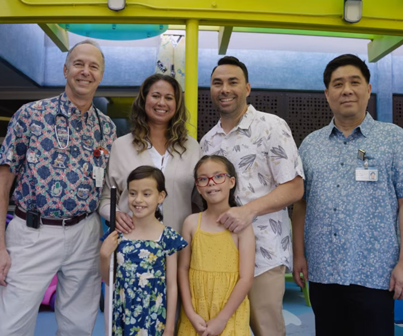 Aurelia Awa (front left) with her family and physicians. From left: Dr. Darryl Glaser, Kapiolani pediatric hematologist/oncologist; Rachel, Quinn, and Kaimi Awa; and Dr. James Sim, Kapiolani pediatric cardiologist.