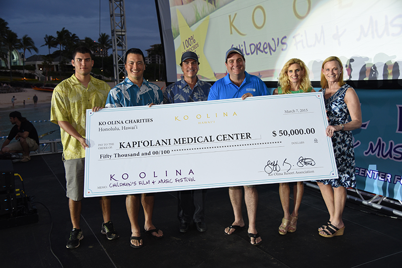 a group posing with a large donation check for $50000