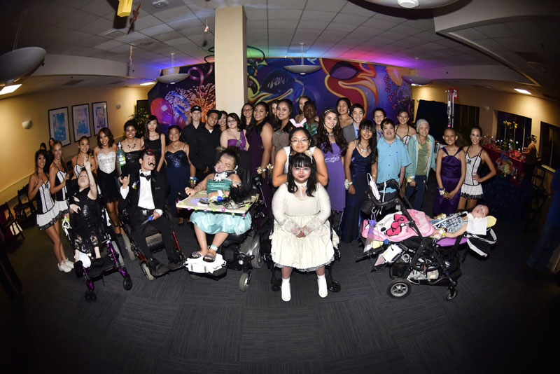 group of young patients posing for a group photo at an Unforgettable Evening event