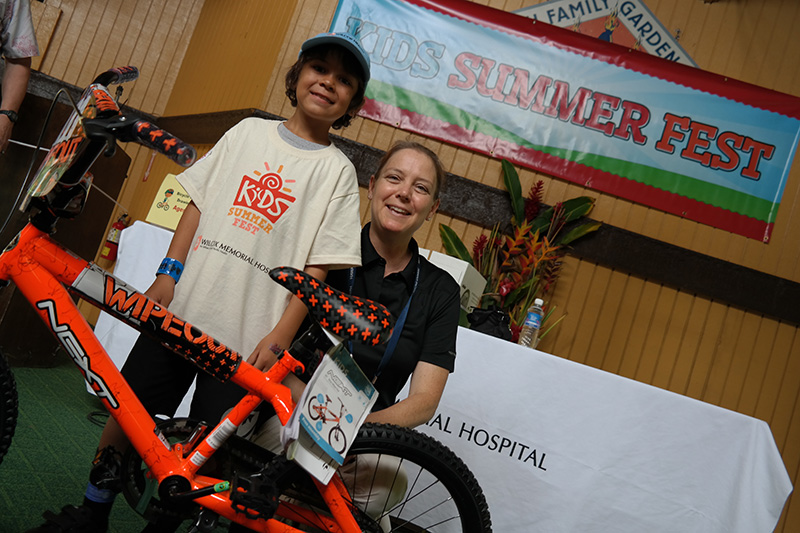 two people posing for a photo with a new bike