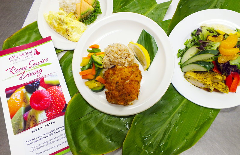 plates of food on top of tea leaves with a menu