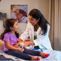 Pediatrician talking to a girl patient