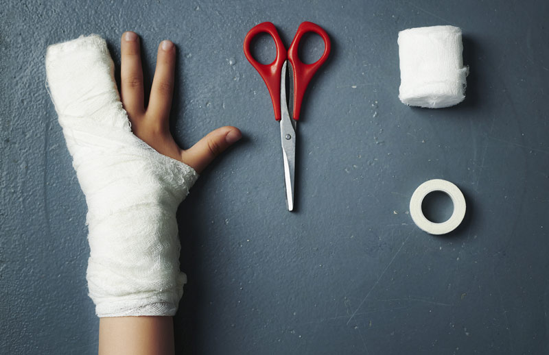 an illustrated injured child hand reaching scissor