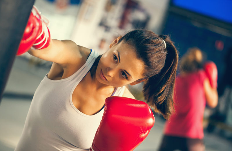 a female boxer punching a bag